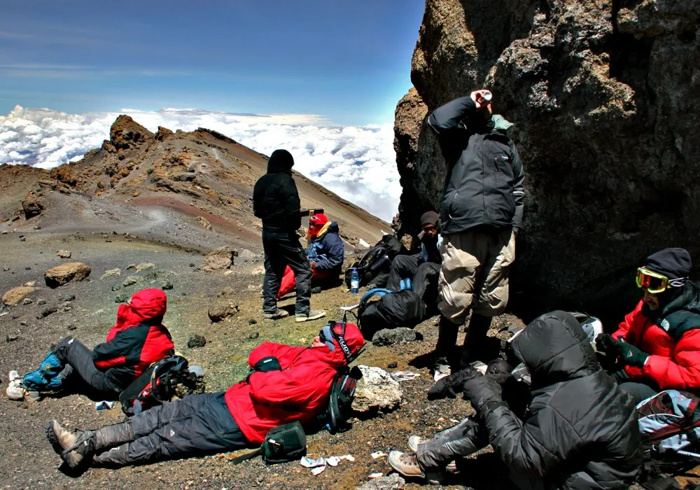 Kilimanjaro hikers resting at Stella Point during their summit climb