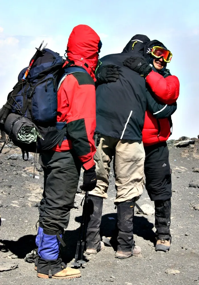 Climbers celebrating together at Uhuru Peak on Mount Kilimanjaro