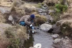 Kilimanjaro mountain crew collecting drinking water from a natural stream