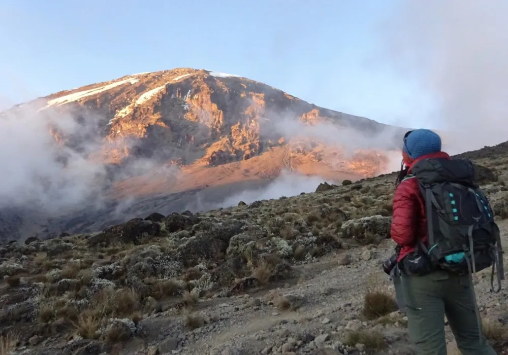 Hiker looking towards Mount Kilimanjaro