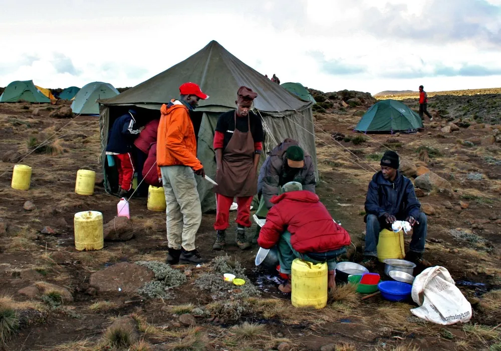 Kilimanjaro mountain crew working behind the scenes at camp