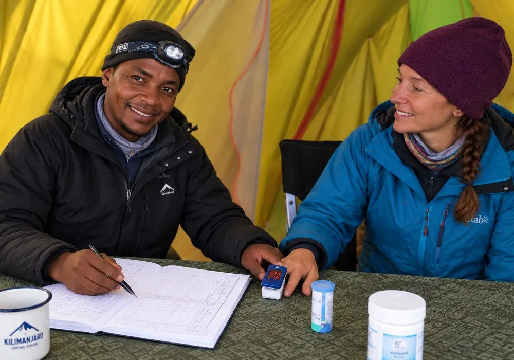 Kilimanjaro guide conducting a health check using a pulse oximeter