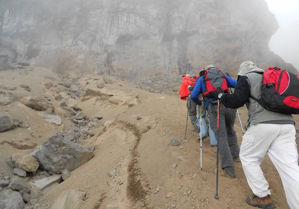 Hikers walking uphill towards Mawenzi on Mount Kilimanjaro