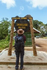 Kilimanjaro hiker at the mountain gate after descending from a climb