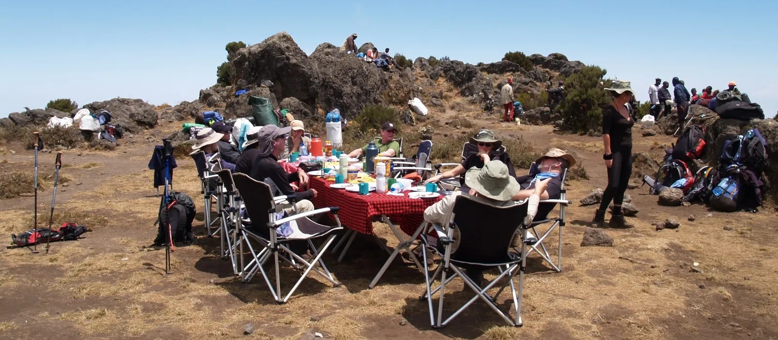 Hikers enjoying a meal together while climbing Mount Kilimanjaro
