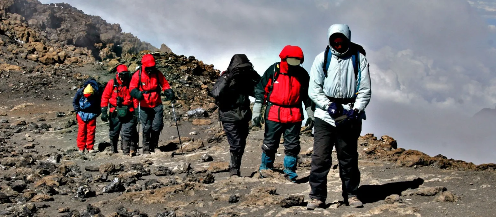 Guide leading hikers during a high-altitude summit attempt on Mount Kilimanjaro