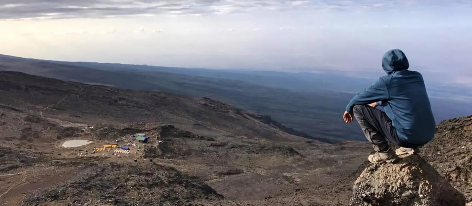 Hiker overlooking the remote northern slopes on the Kilimanjaro Rongai Route