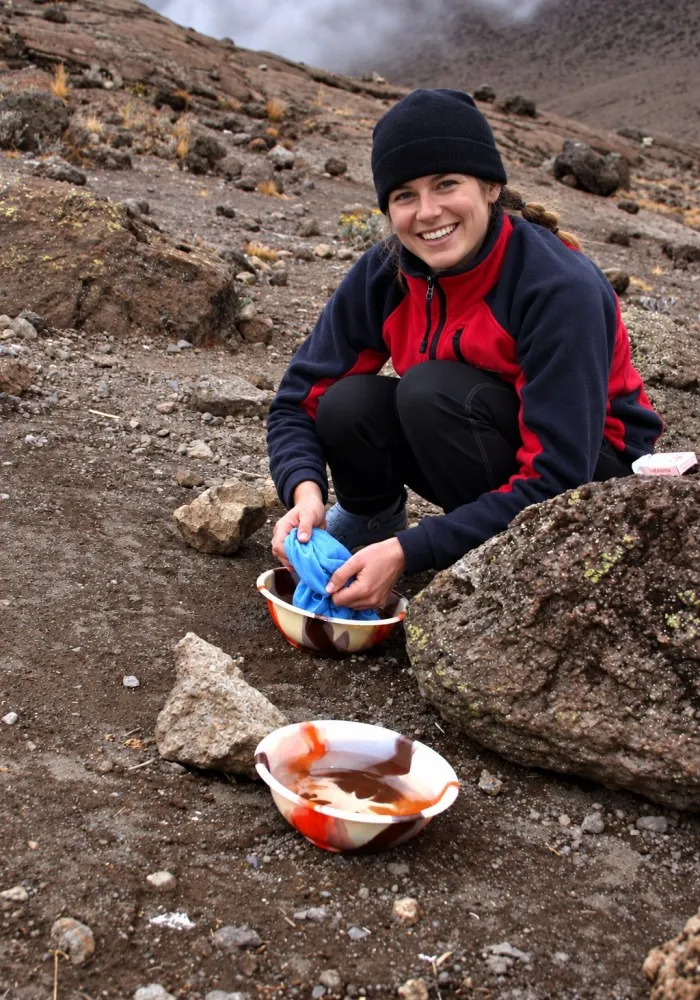 Hiker washing with warm water after a day climbing Mount Kilimanjaro