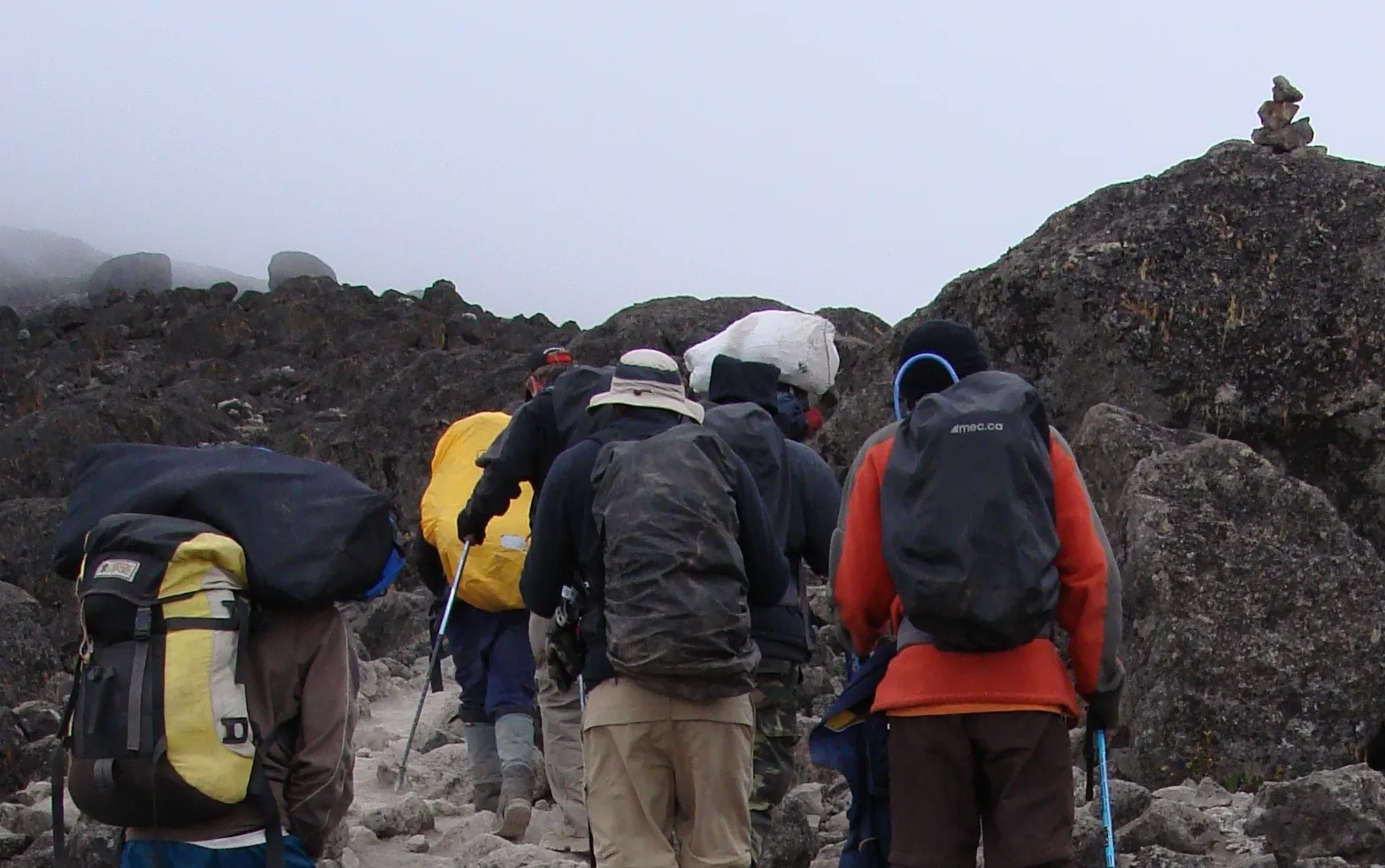 Kilimanjaro hikers carrying daypacks while walking between camps