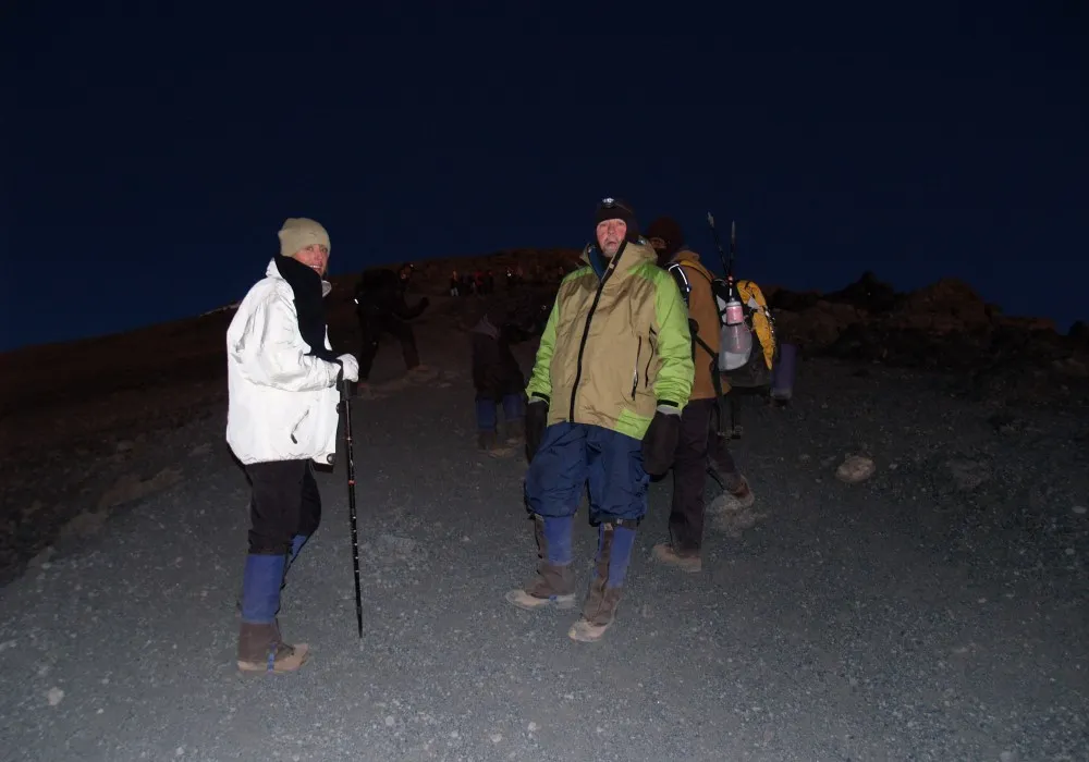 Hikers climbing towards Uhuru Peak before sunrise on Mount Kilimanjaro