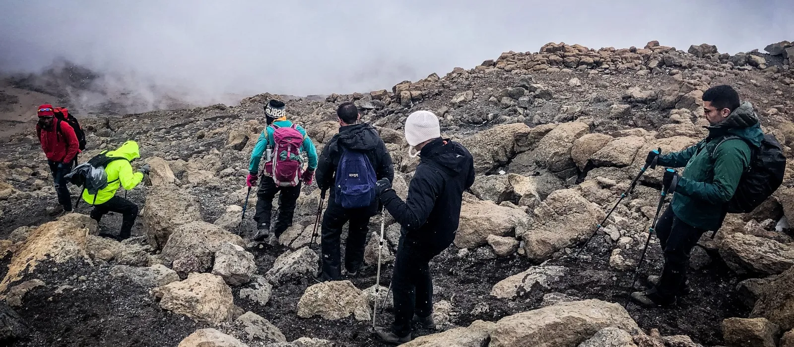Hikers climbing Mount Kilimanjaro on a high-altitude mountain trail
