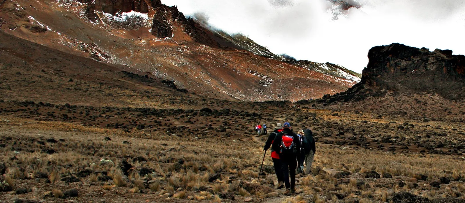 Hikers trekking through the high-altitude landscape of Mount Kilimanjaro